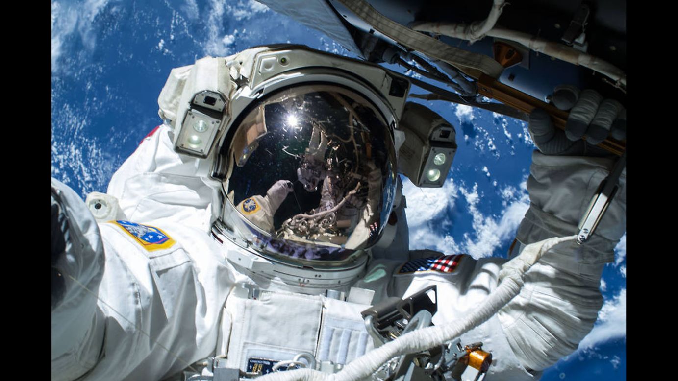 NASA astronaut Terry Virts is reflected off the visor of Barry Wilmore as Wilmore snaps a selfie during a spacewalk on Saturday, February 21.