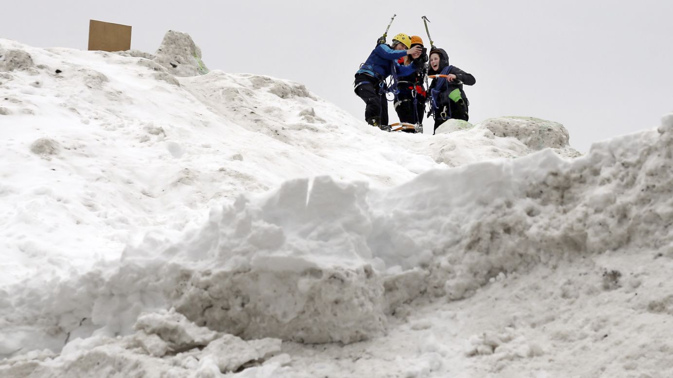Three students from the Massachusetts Institute of Technology take a selfie after jokingly using mountaineering gear to make their way up a massive snow pile on the MIT campus Wednesday, February 18. The mountain of excess snow was dubbed the "Alps of MIT," and it was used for climbing and sledding.