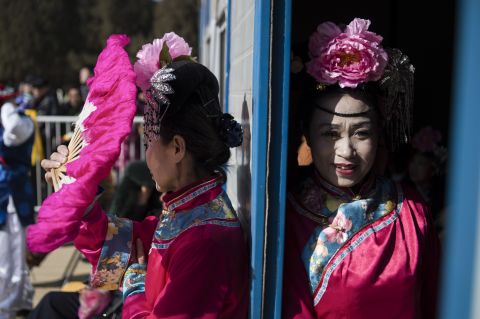 FEBRUARY 25 - BEIJING, CHINA: Women wearing traditional costumes wait prior to a show at Ditan Park temple fair during the <a href="http://cnn.com/2015/02/08/asia/gallery/lunar-new-year-2015/">Chinese Lunar New Year.</a> Millions of Chinese are celebrating the Spring Festival, the most important holiday on the country's calendar, which marks the beginning of the <a href="http://cnn.com/2015/02/12/asia/year-of-the-goat-sheep-ram/">Year of the Sheep</a> in 2015.