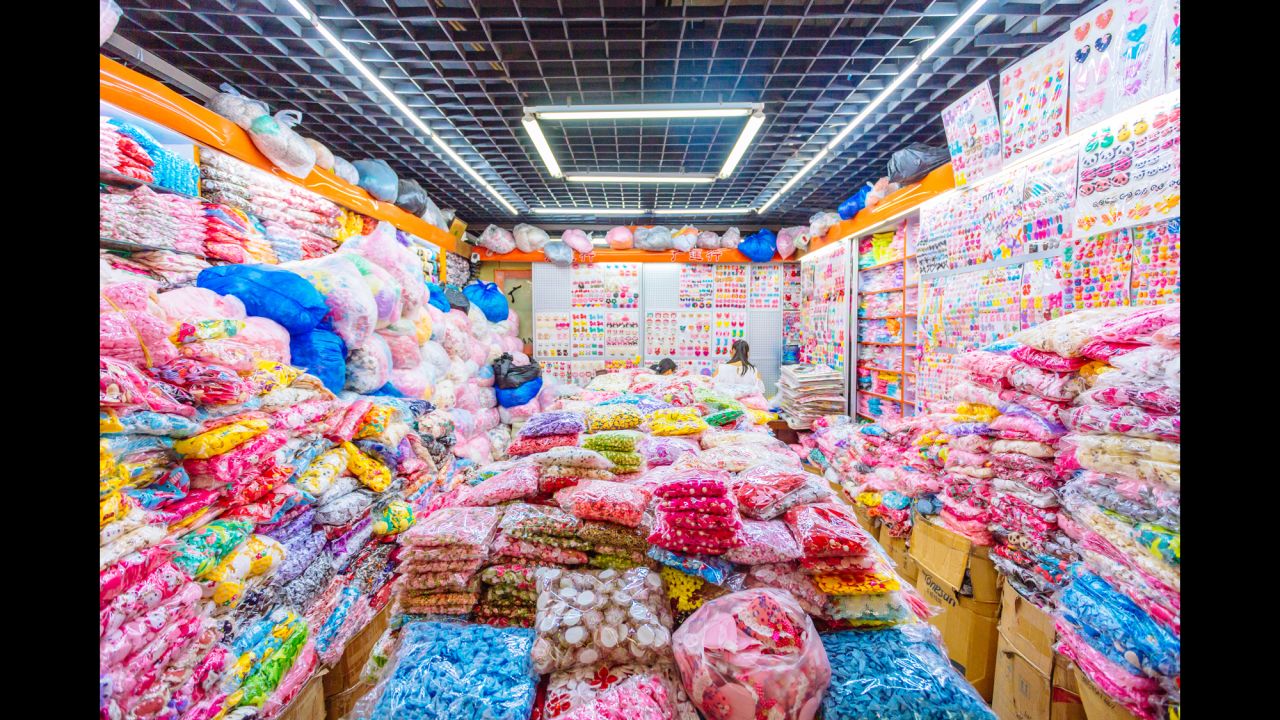 Women are barely visible in their novelty fabric booth.
