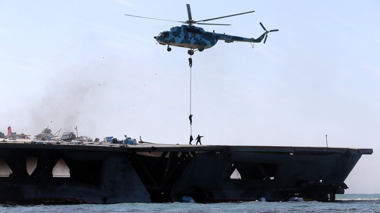 Iran's elite Revolutionary Guard troops rappel down a helicopter onto the vessel. 