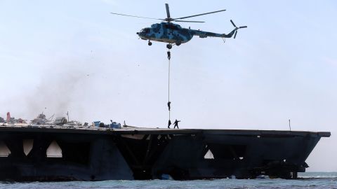 Iran's elite Revolutionary Guard troops rappel down a helicopter onto the vessel. 