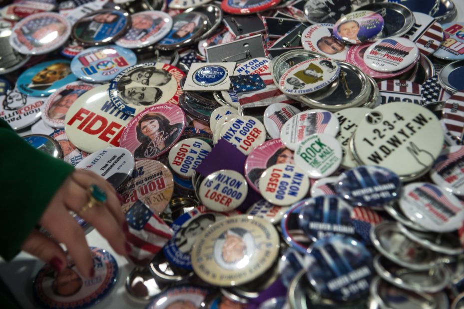 A woman browses through conservative politicas badges at the annual Conservative Political Action Conference.