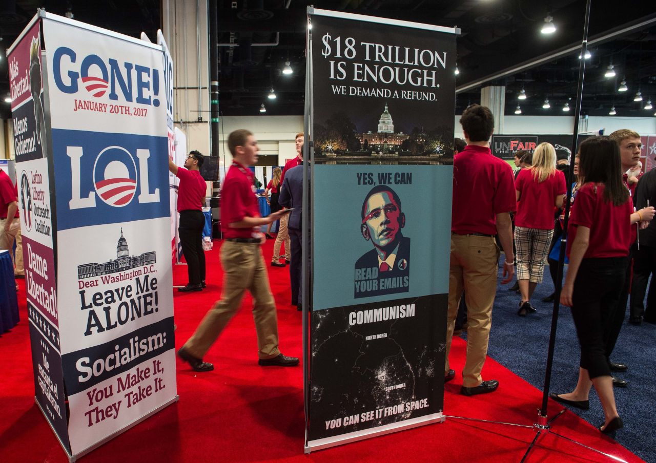 Volunteers walk by a stand at the annual Conservative Political Action Conference.