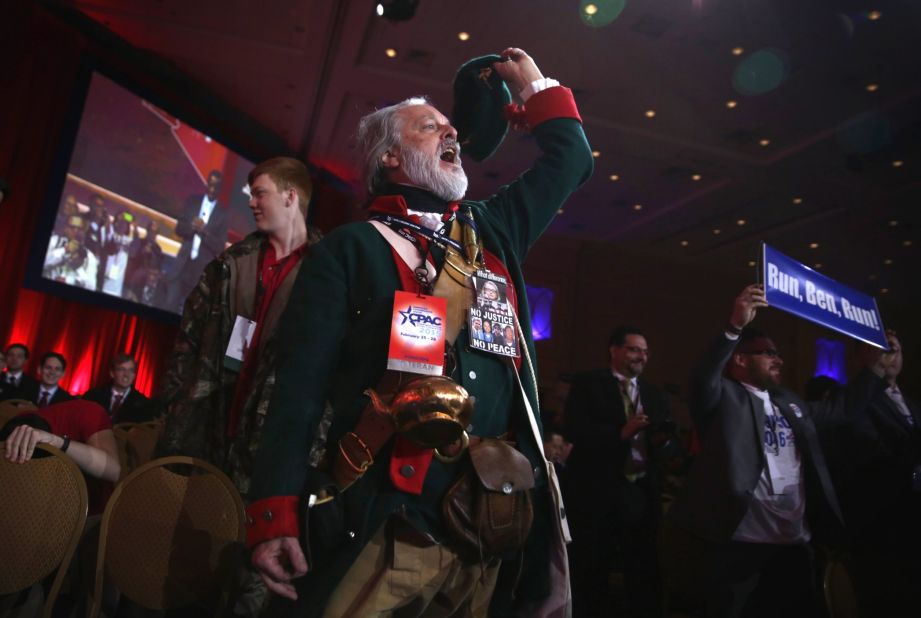 William Temple of the Golden Isles Tea Party in Georgia, dressed as Button Gwinnett, the second signer on the United States Declaration of Independence, cheers as Ben Carson speaks.