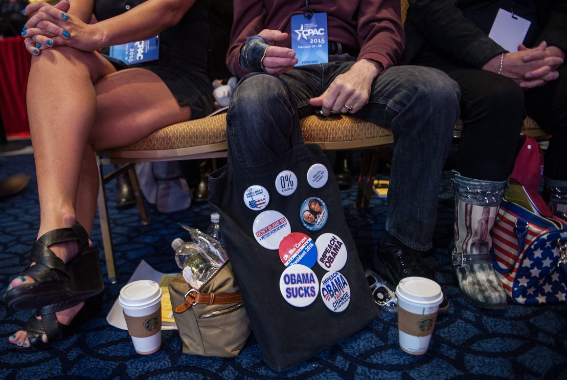 A man displays pins as he attends the annual Conservative Political Action Conference.