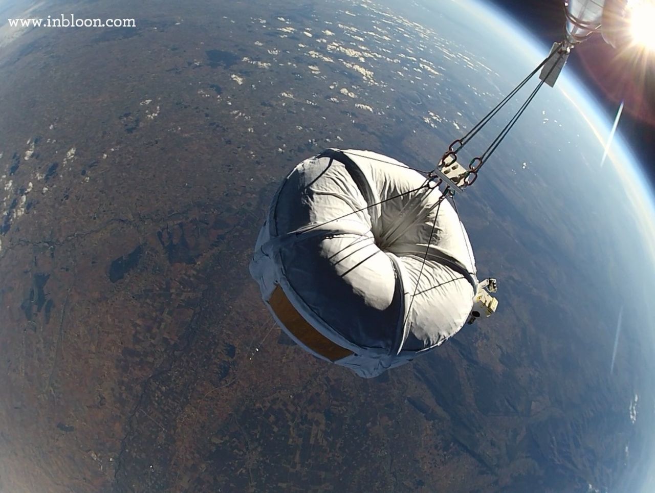 A "Micro Bloon" spherical capsule on a test flight, far above the Earth.