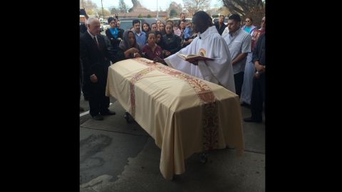 Pasco, Washington -- The Rev. Lutakome Nsubuga blesses the casket of Antonio Zambrano-Montes before the funeral on February 25, 2010. 