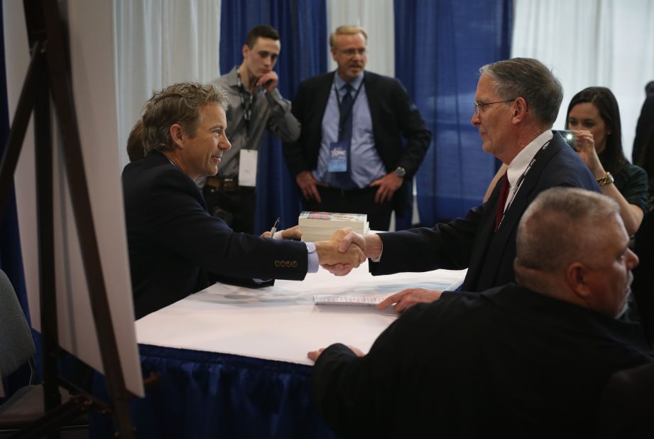 Rand Paul signs books at CPAC.