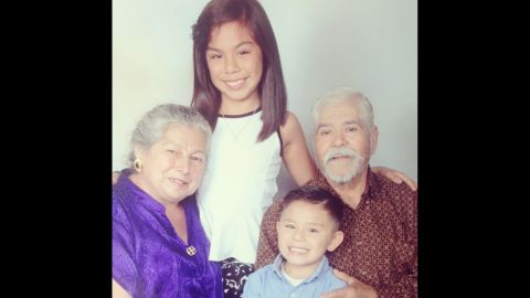 Leyah and Juanito take a photo with their grandparents, Herminio and Juanita. Herminio immigrated from Mexico in 1959.