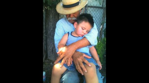 Herminio holds his grandson in 2011. "My father has always worked with his hands and this picture captures the roughness and contour of his hands as well as the sweet innocence of my son." 