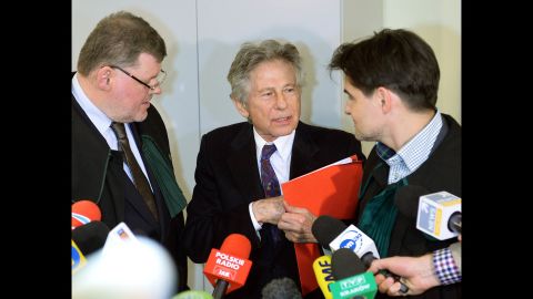Polanski speaks with his lawyers as he leaves court in Krakow, Poland, on February 25.