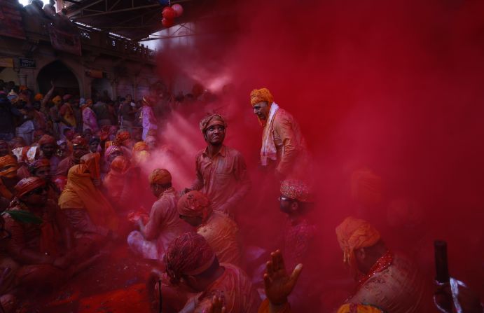 FEBRUARY 27 -- BARSANA, INDIA: Hindu men from the village of Nandgaon throw colored powder at each other as part of the region's Lathmar Holi festivities. During Lathmar Holi, men from Nandgaon -- said to be the home of the Hindu god Krishna -- tease women from neighboring Barsana -- the home of Krishna's consort, Radha. In response, Barsana's women "beat" the men with wooden sticks.