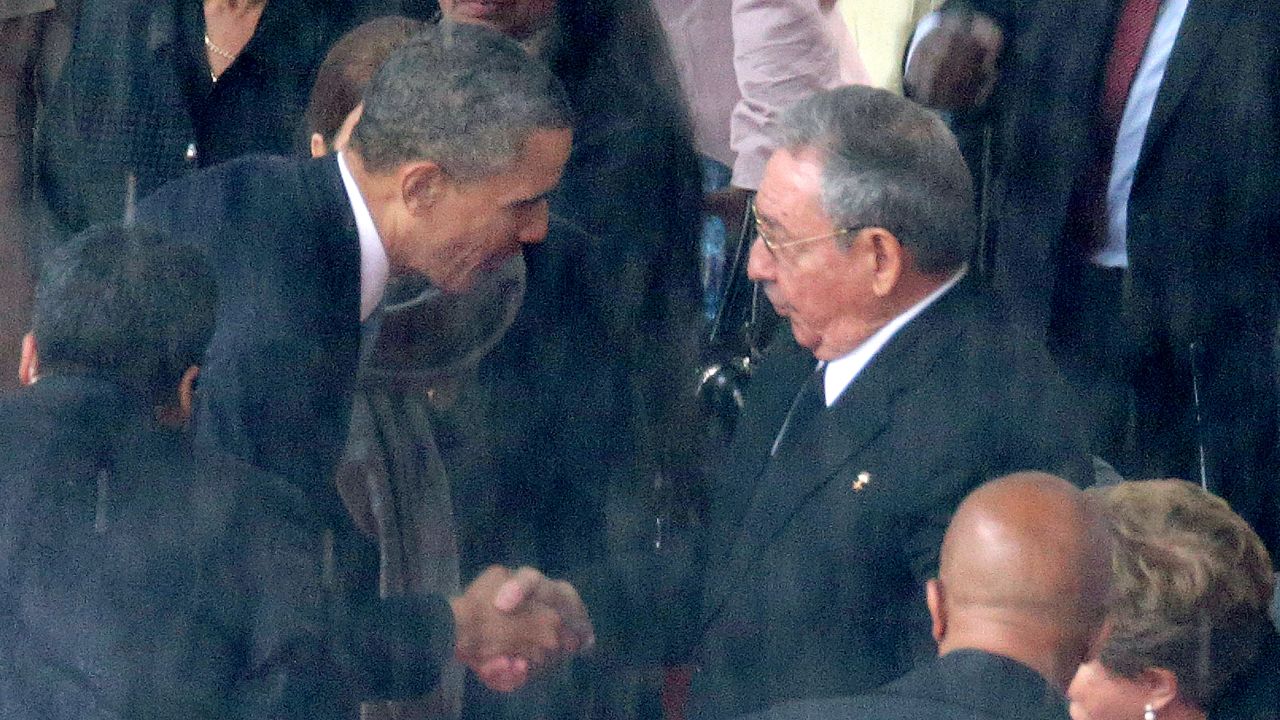 JOHANNESBURG, SOUTH AFRICA - DECEMBER 10:  (EDITORS NOTE: Retransmission of #454753083 with alternate crop.) U.S. President Barack Obama (L) shakes hands with Cuban President Raul Castro during the official memorial service for former South African President Nelson Mandela at FNB Stadium December 10, 2013 in Johannesburg, South Africa. Over 60 heads of state have travelled to South Africa to attend a week of events commemorating the life of former South African President Nelson Mandela. Mr Mandela passed away on the evening of December 5, 2013 at his home in Houghton at the age of 95. Mandela became South Africa's first black president in 1994 after spending 27 years in jail for his activism against apartheid in a racially-divided South Africa.  (Photo by Chip Somodevilla/Getty Images)