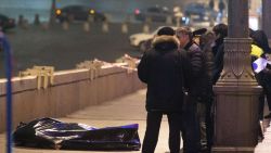 Russian police investigators stand near the body of Russian opposition leader Boris Nemtsov, covered by plastic, on Bolshoi Moskvoretsky bridge near St. Basil cathedral in central Moscow on February 28, 2015. Russian opposition leader Boris Nemtsov, a fierce critic of President Boris Yeltsin, was shot dead in central Moscow ahead of a major opposition rally this weekend, investigators and police said. AFP PHOTO / DMITRY SERERYAKOV (Photo credit should read DMITRY SEREBRYAKOV/AFP/Getty Images)