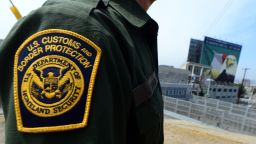 A US Border Patrol agent stands near a crossing to Mexico