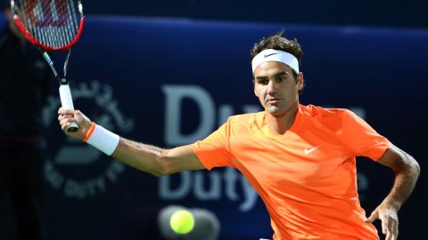 Roger Federer returns the ball to Novak Djokovic during their final match of the Dubai Championships.