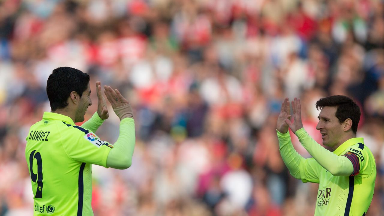 Luis Suarez (left) and Lionel Messi celebrate after Barcelona's third goal in its La Liga match with Granada.