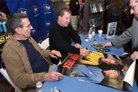 Nimoy and Shatner sign posters and other memorabilia while promoting the video "Mind Meld: Secrets Behind the Voyage of a Lifetime" at FYE in Los Angeles on March 17, 2002. 