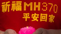 A relative of one of the Chinese passengers from the missing Malaysia Airlines flight MH370 holds a candle before offering prayers at Thean Hou Temple in Kuala Lumpur on March 1, 2015. The visit to the temple comes nearly a year after Malaysian Airlines MH370 went missing en route from Kuala Lumpur to Beijing with 239 people on board in March 2014. AFP PHOTO / MOHD RASFAN (Photo credit should read MOHD RASFAN/AFP/Getty Images)