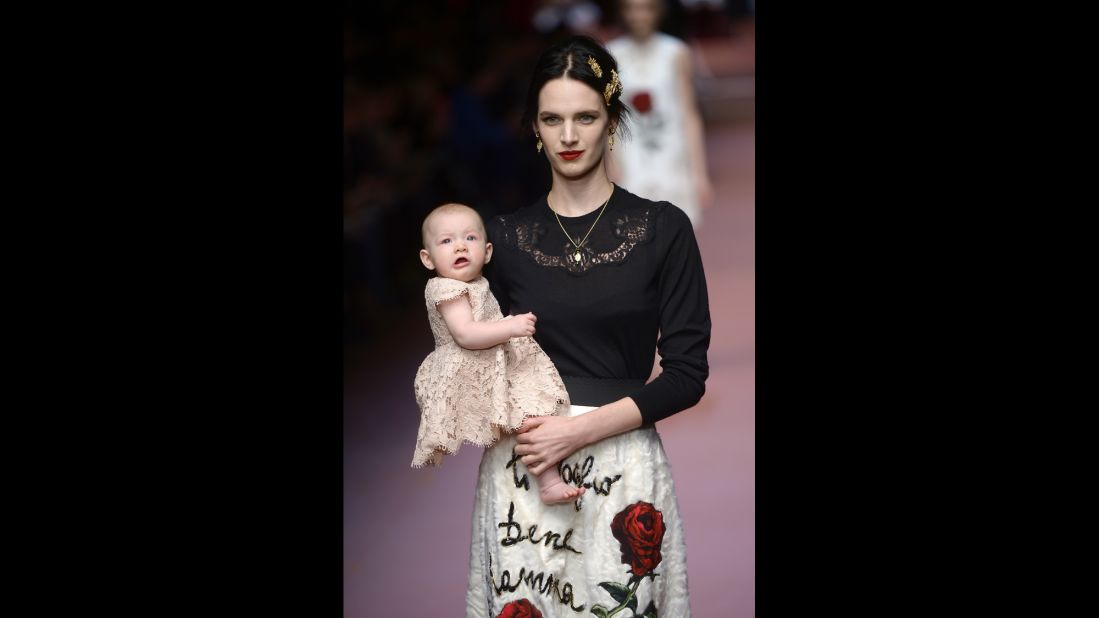 Model Ashleigh Good walks the runway with her daughter for fashion house Dolce & Gabbana.