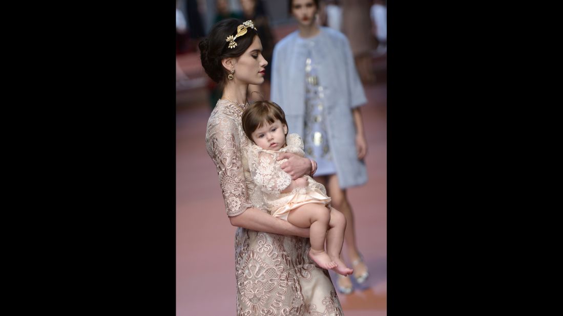 A model and baby wear matching Italian lace dresses.