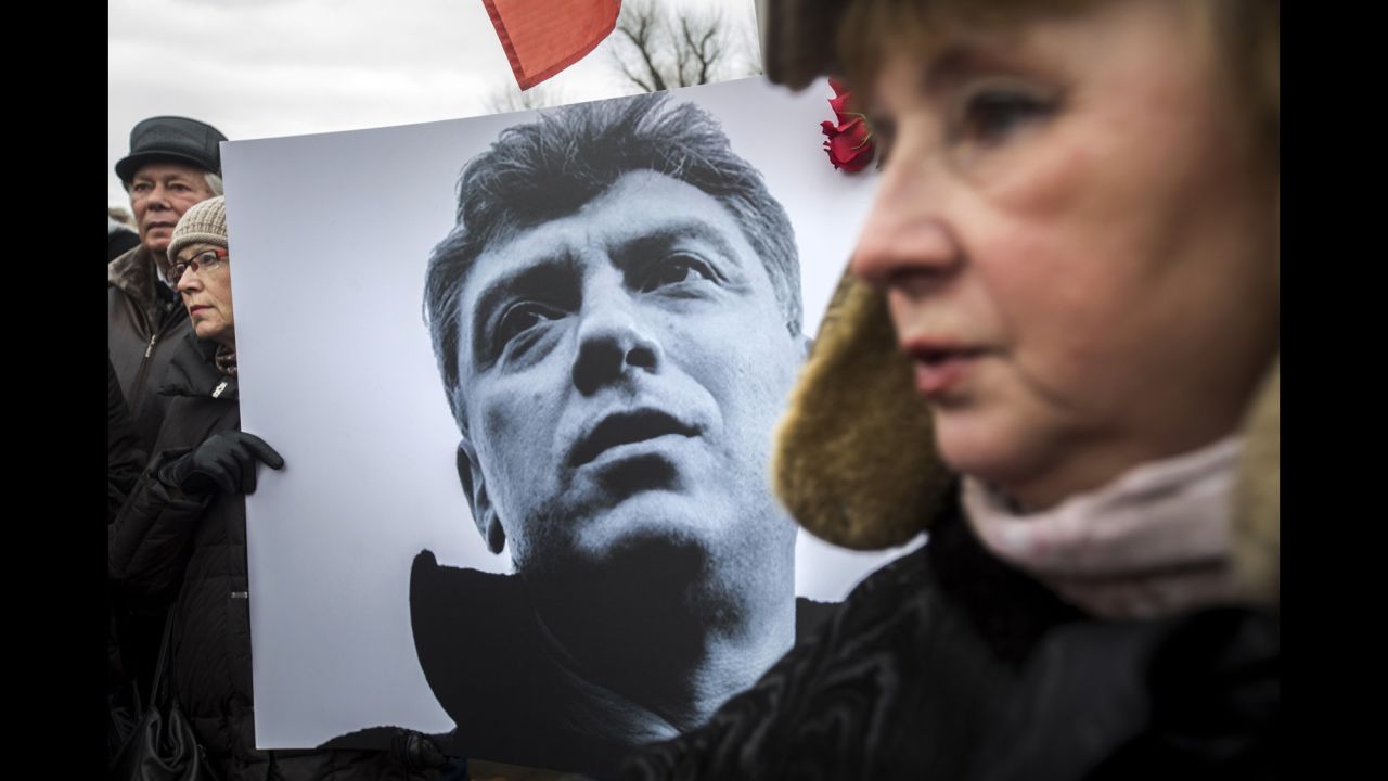 A woman carries a sign with Nemtsov's image during a march in St. Petersburg, Russia, on March 1.