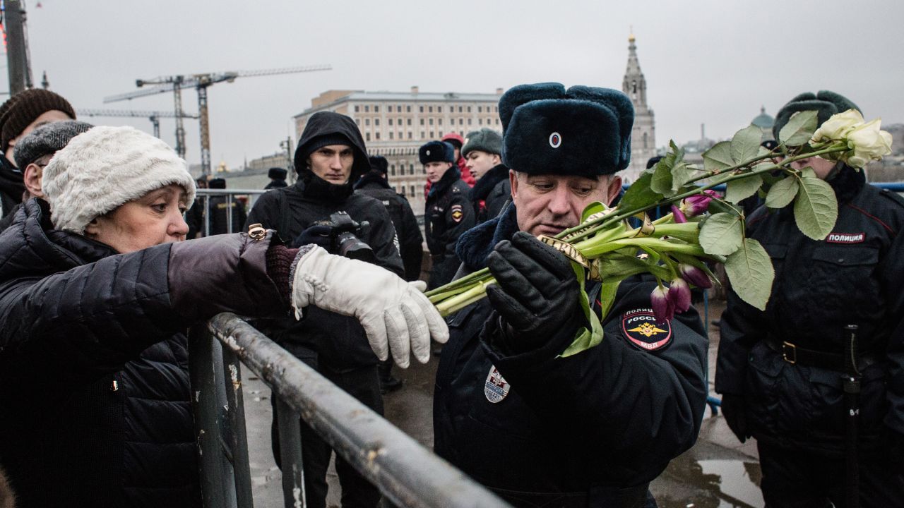 A woman leaves flowers in Nemtsov's memory during a march in central Moscow on March 1.