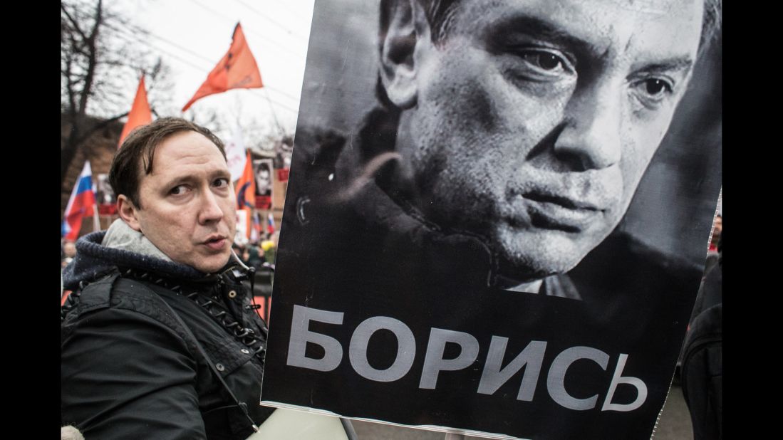 A man carries a sign with Nemtsov's image March 1 in Moscow.