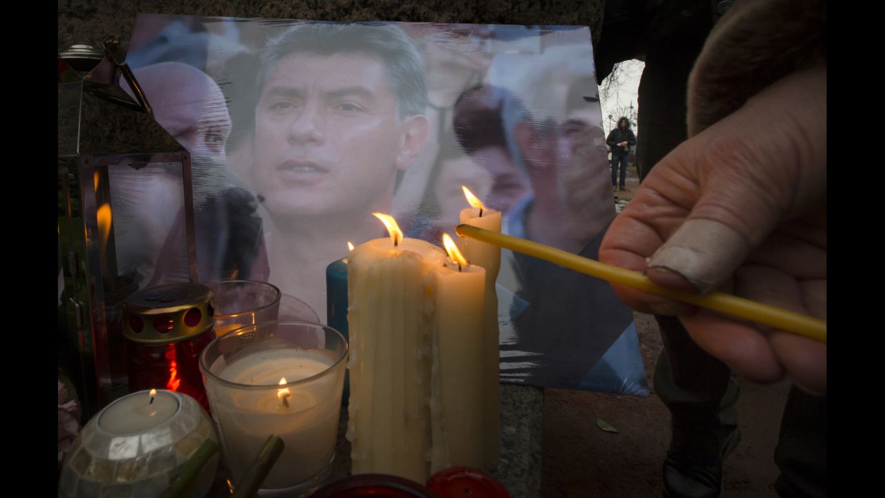 People light candles at a monument dedicated to political prisoners in St. Petersburg on Saturday, February 28.