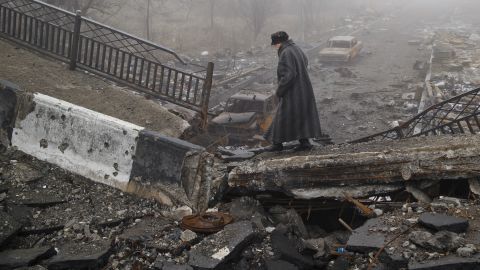 A woman makes her way across a  bridge destroyed in heavy fighting in Donetsk, Ukraine, on March 1.