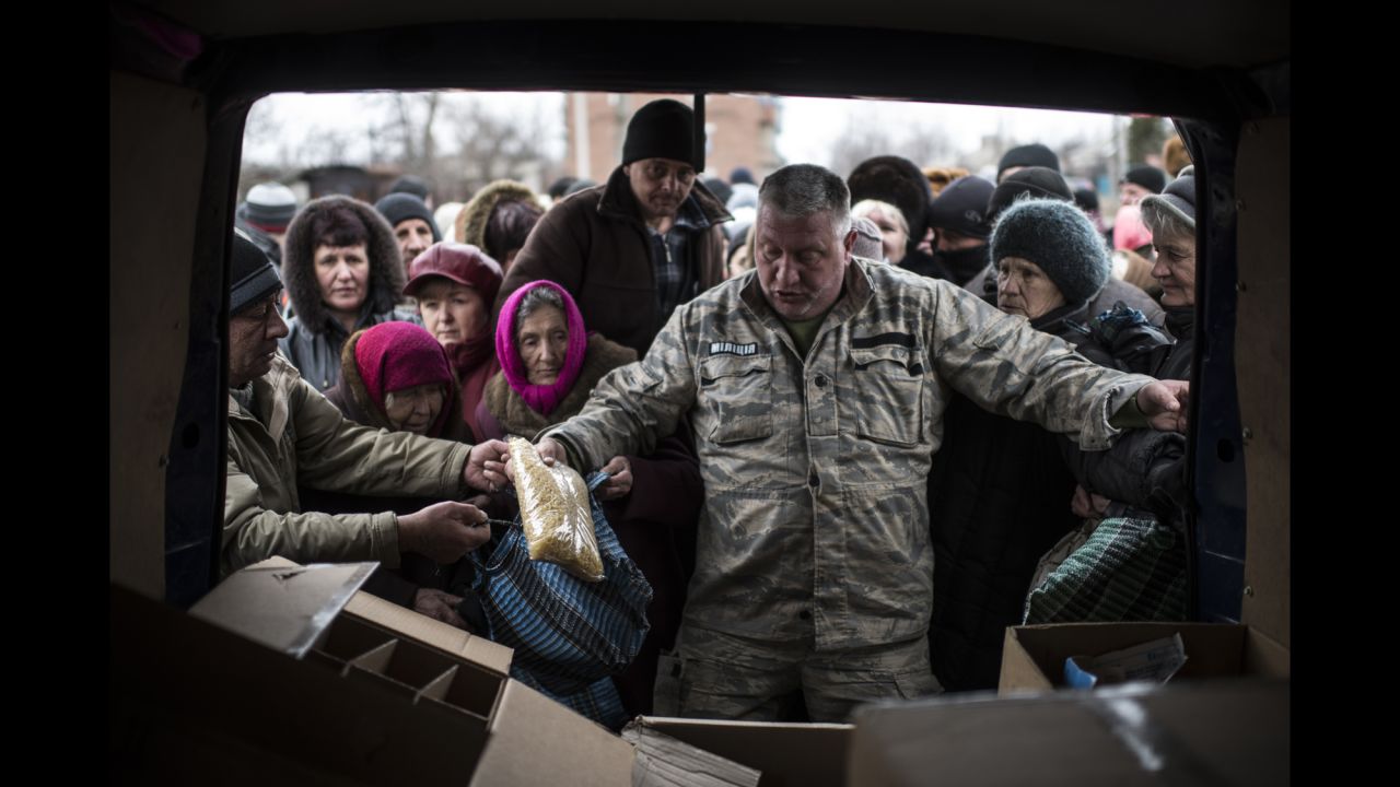 A volunteer gives humanitarian aid to residents of Popasna, Ukraine, on Saturday, February 28.