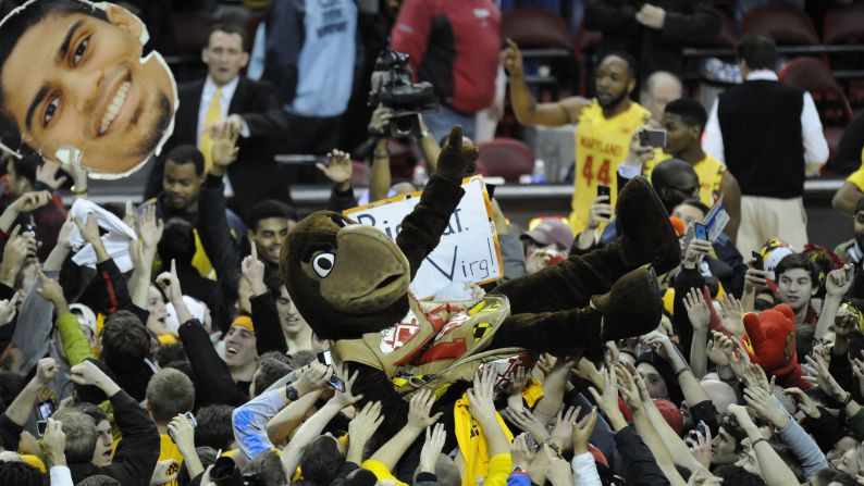 Testudo, the mascot of the Maryland Terrapins, is held up by fans who stormed the court after the men's basketball team upset Wisconsin 59-53 on Tuesday, February 24.
