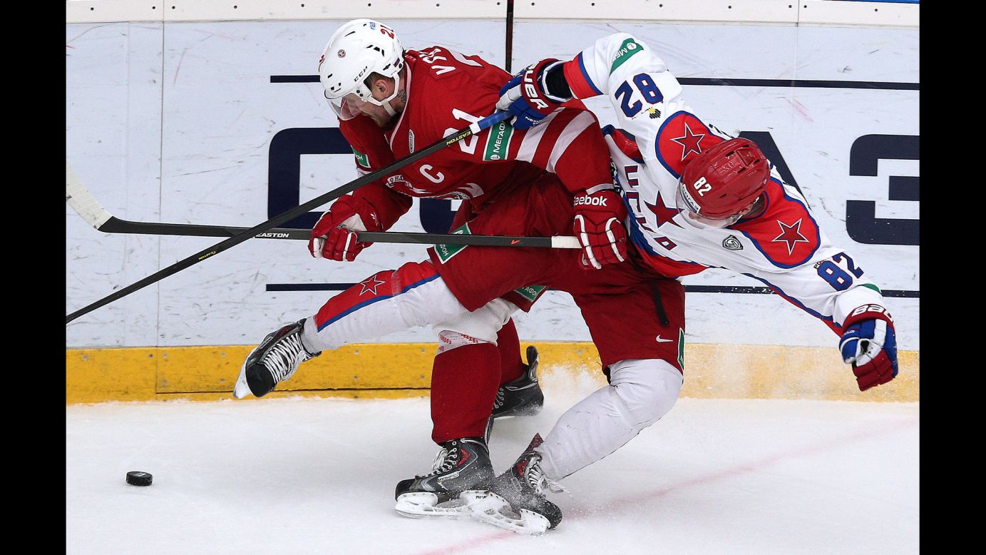 Nikita Vyglazov, left, and Ondrej Nemec battle for the puck during a KHL hockey game in Moscow between Vyglazov's Vityaz and Nemec's CSKA on Tuesday, February 24.