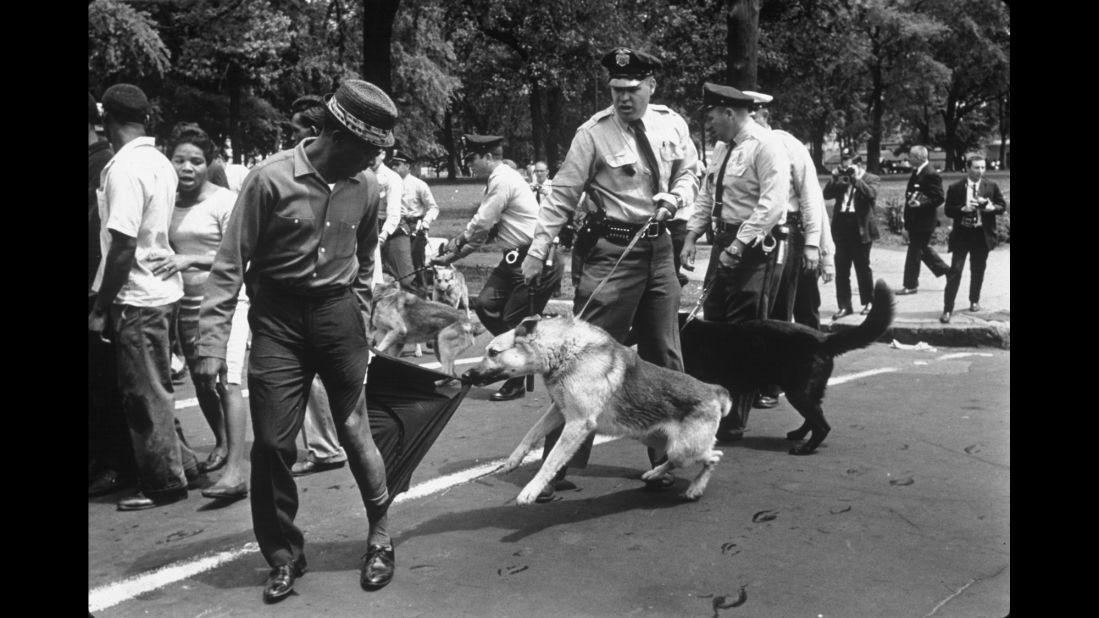 A man looks calmly over his shoulder as a police dog in Birmingham rips his trouser leg in 1963. "The figure in the photo is a perfect symbol of nonviolence," Kasher said. "You know, the man is standing there, taking it, not fighting back, amid this incredible rush of hatred and violence and as another dog is charging right at Moore's -- at the viewer's -- face."