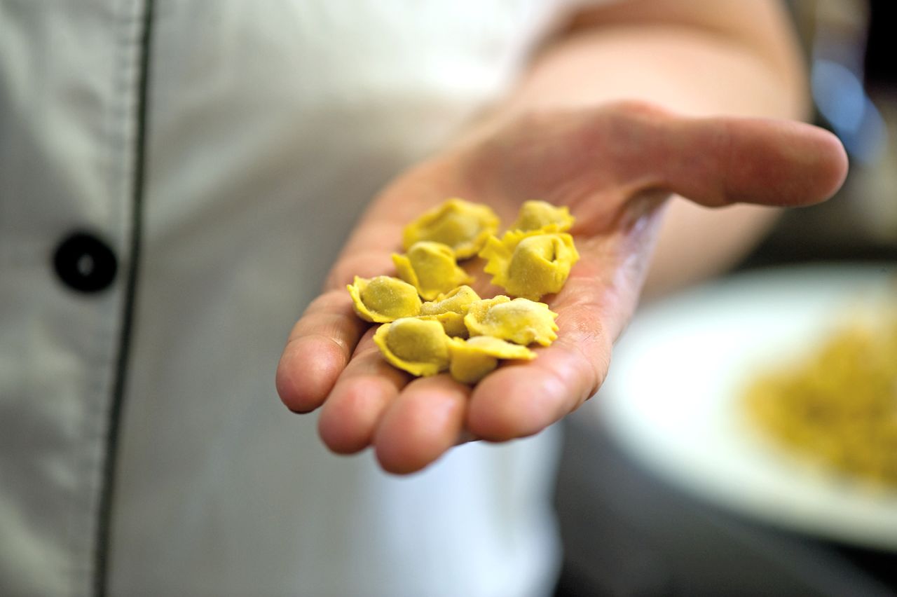Tortellino -- the plural form of tortellini -- is a Modena specialty. Handmade pasta shaped like a knot, it can be filled with many ingredients, such as parmigiano and ham, seasoned hen or beef.