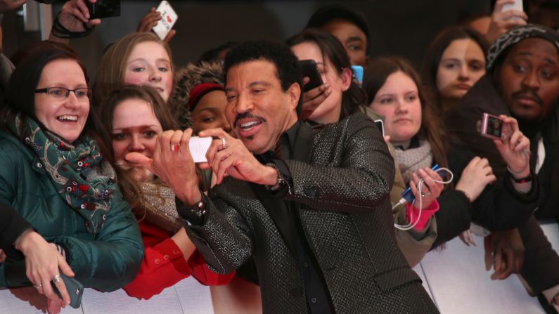 Hello? Is this the selfie you're looking for? Singer Lionel Richie takes a photo with fans as he arrives at the Brit Awards in London on Wednesday, February 25.