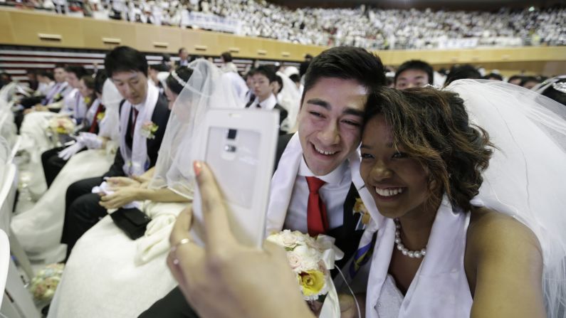 A couple takes a selfie before a mass wedding ceremony in Gapyeong, South Korea, on Tuesday, March 3.