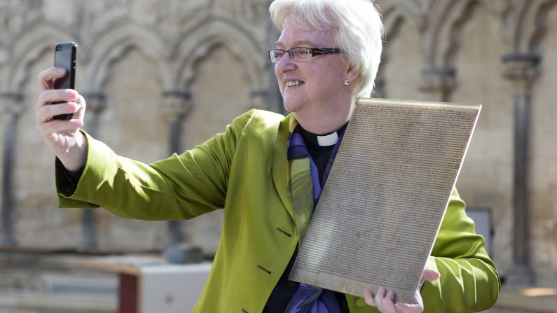 The Rev. June Osborne Dean takes a selfie with the Salisbury Cathedral's original copy of the Magna Carta during an exhibition in Salisbury, England, on Friday, February 27. It is one of <a href="index.php?page=&url=http%3A%2F%2Fwww.cnn.com%2F2015%2F02%2F02%2Feurope%2Ffour-magna-carta-copies-united%2F" target="_blank">four original copies remaining</a> of the historic document, which established the principle that everyone, including the King of England himself, was subject to the rule of law.