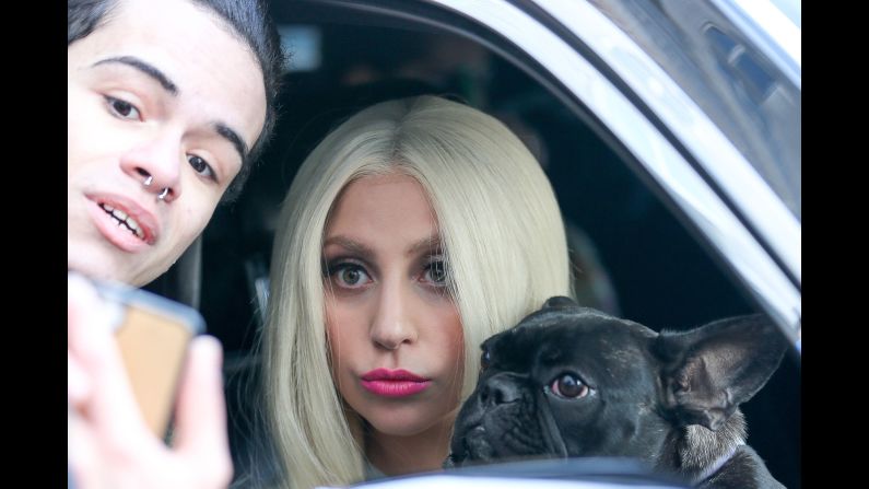 A fan in New York gets a photo with Lady Gaga and the singer's dog on Sunday, March 1.