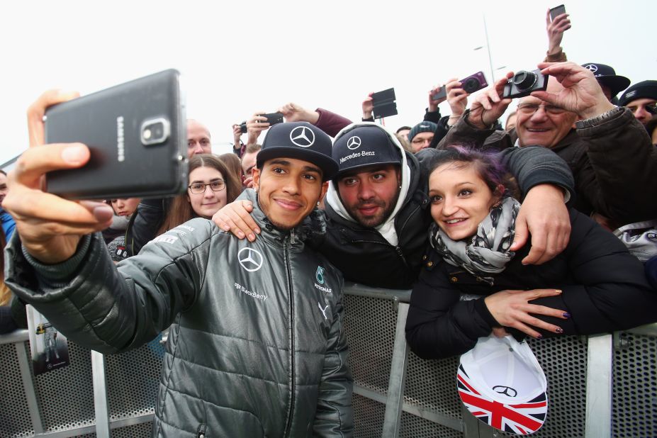 The Mercedes driver is not shy of a selfie to post to his millions of fans on social media. Here Hamilton meets fans in Stuttgart, Germany after his 2014 championship triumph.