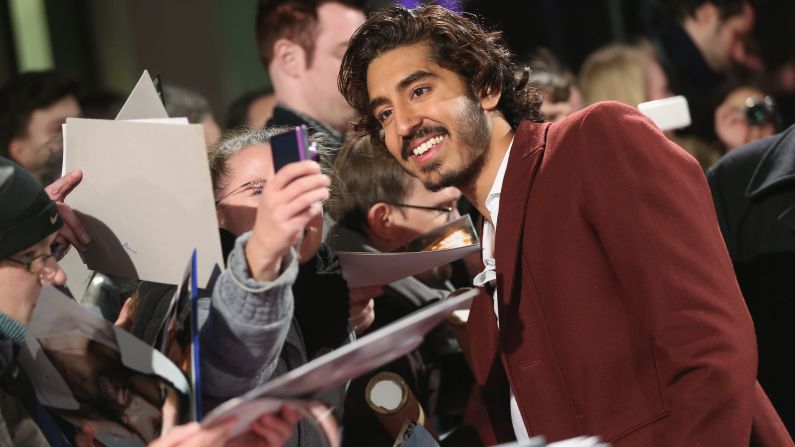 Actor Dev Patel stops to take a photo with a fan in Berlin during a promotional event for the film "Chappie" on Friday, February 27.