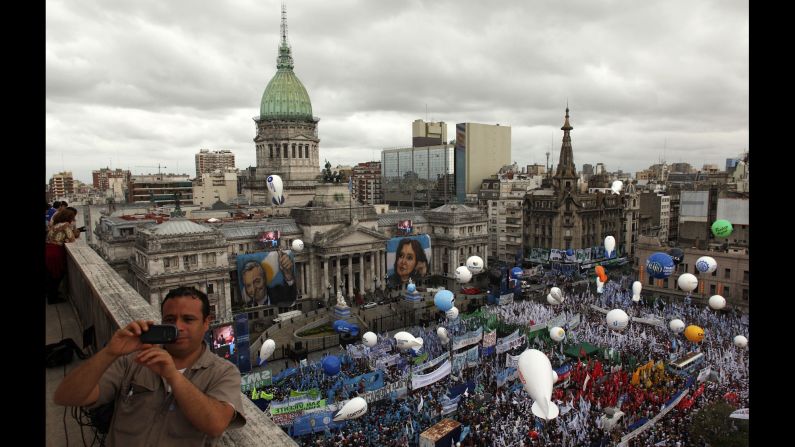 A man takes a photo Sunday, March 1, as supporters of Argentine President Cristina Fernandez de Kirchner gather outside Congress in Buenos Aires. 
