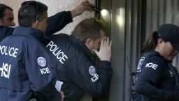 ROWLAND HEIGHTS, CA. - MARCH 3: Immigration and Customs Enforcement (ICE) agents from the Department of Homeland Security look into the window of an apartment while executing search warrants during an ongoing investigation of alleged birth tourism centers on March 3, 2015 in Rowland Heights, California. Agents from multiple federal and local law enforcement agencies executed search warrants in Orange, Los Angeles and San Bernardino counties on Tuesday morning. (Photo by Mark Boster/Los Angeles Times via Getty Images)
