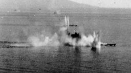 The Japanese battleship Musashi under intense attack by Task Force 38 aircraft in the Sibuyan Sea. A destroyer is also receiving attacks beyond the battleship.
