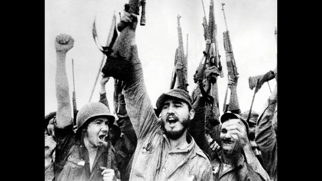 Castro and his revolutionaries hold up their rifles in January 1959 after overthrowing Batista.