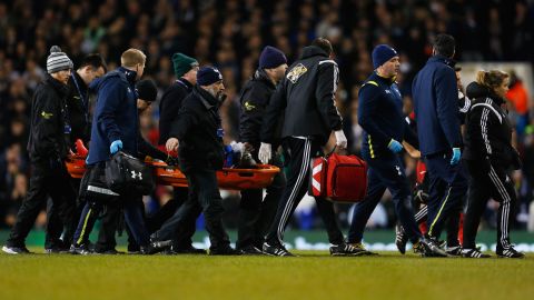Swansea striker Bafetimbi Gomis is stretchered off the field at Tottenham after he collapsed. 
