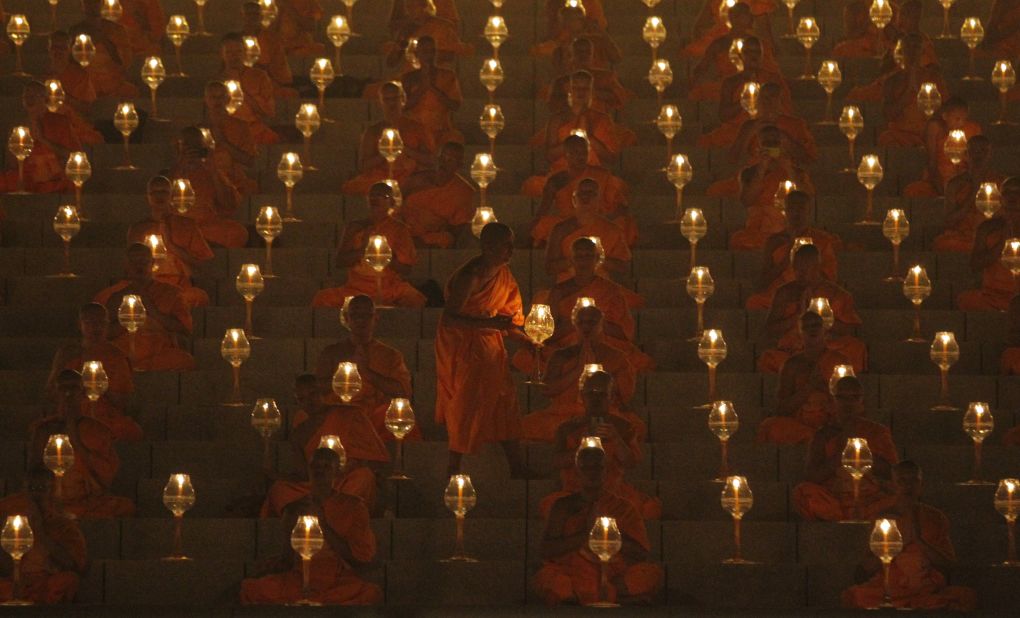 MARCH 4 - PATHUM THANI PROVINCE, THAILAND: Buddhist monks pray and gather at Wat Phra Dhammakaya temple to participate in Makha Bucha Day ceremonies. The religious holiday marks the anniversary of Buddha's mass sermon to the first 1,250 newly ordained monks.