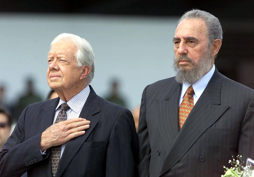 Castro and former US President Jimmy Carter listen to the US national anthem after Carter arrived in Havana for a visit in May 2002.