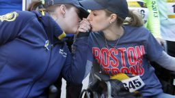 Survivors Erika Brannock, left, and  Rebekah Gregory DiMartino, embrace in their wheelchairs as they head to the finish line of the Boston Marathon Tribute Run in Boston, Saturday, April 19, 2014.